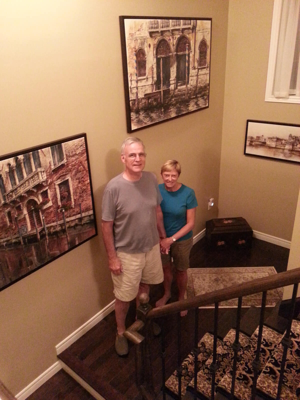 Happy customers after Alex Krajewski installed Venice over sized framed canvas at customers' home